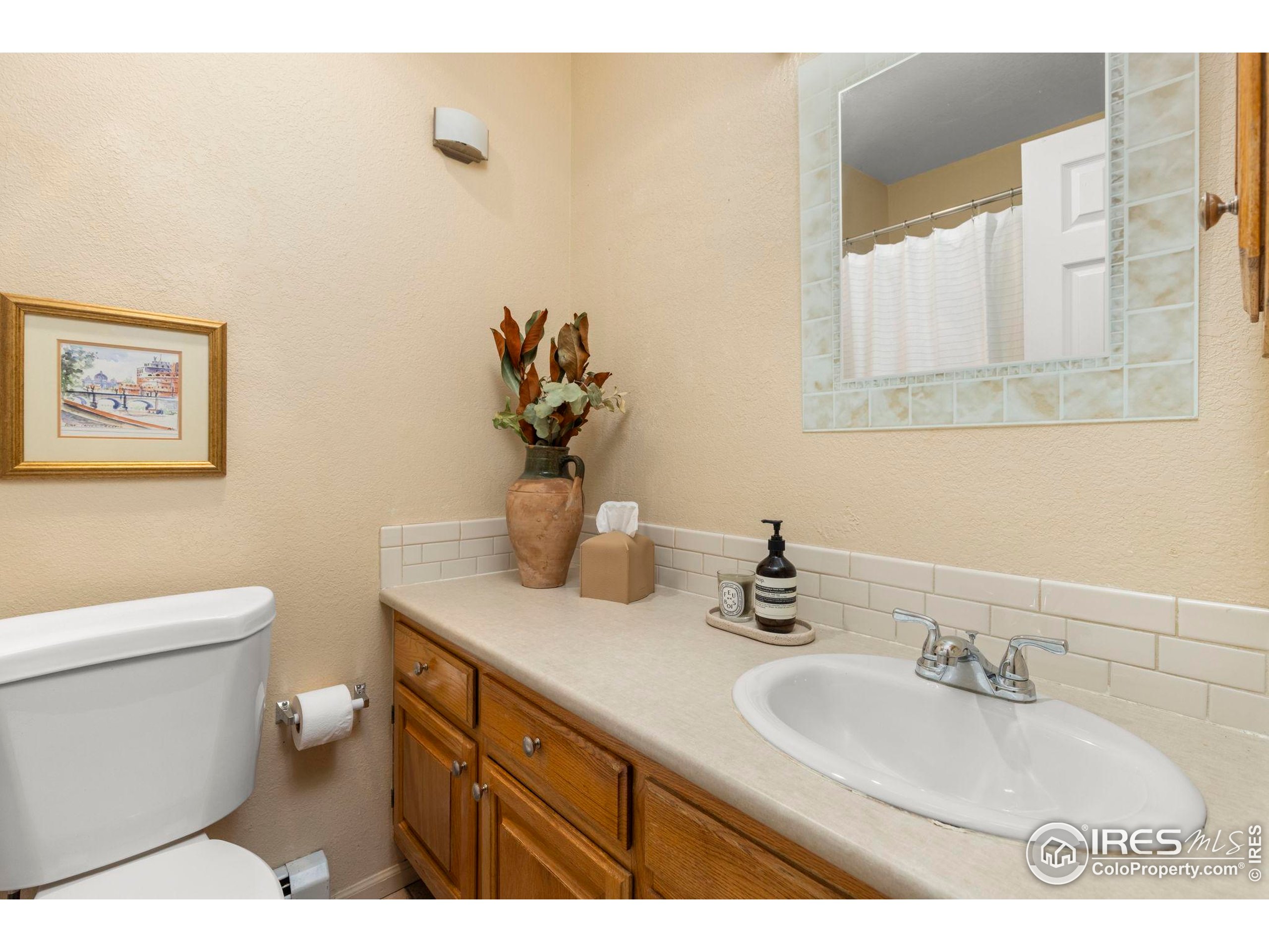 1430 18th Street, Unit 1 Boulder, CO 80302 - Photo 12 of 29 a bathroom with a sink a toilet and mirror