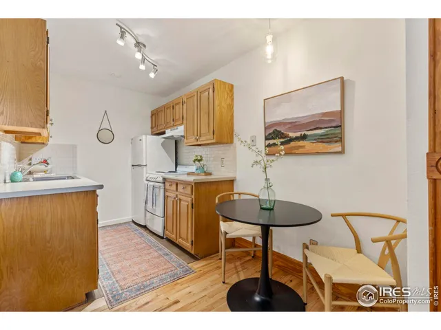 a kitchen with a table and chairs