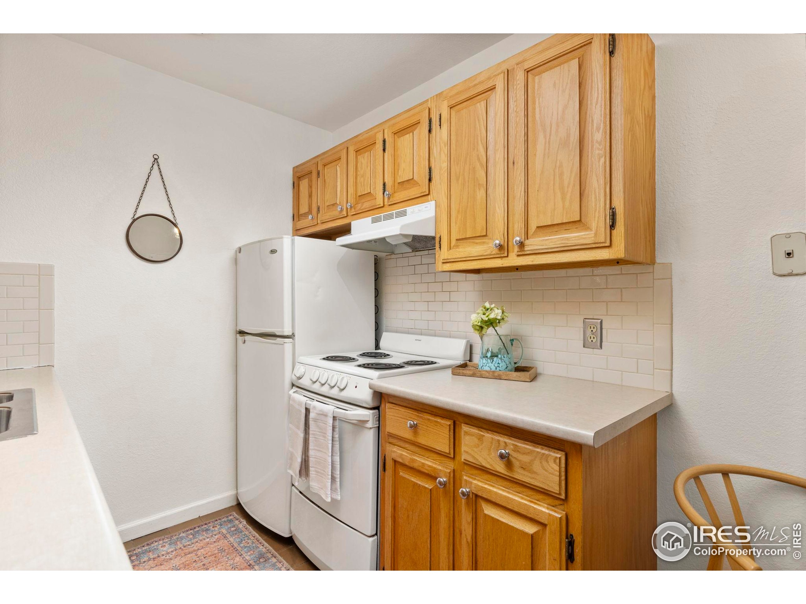 1430 18th Street, Unit 1 Boulder, CO 80302 - Photo 7 of 29 a kitchen with stainless steel appliances granite countertop a stove a sink and a microwave
