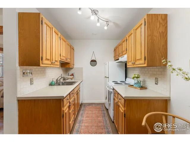 a kitchen with a sink a stove and cabinets