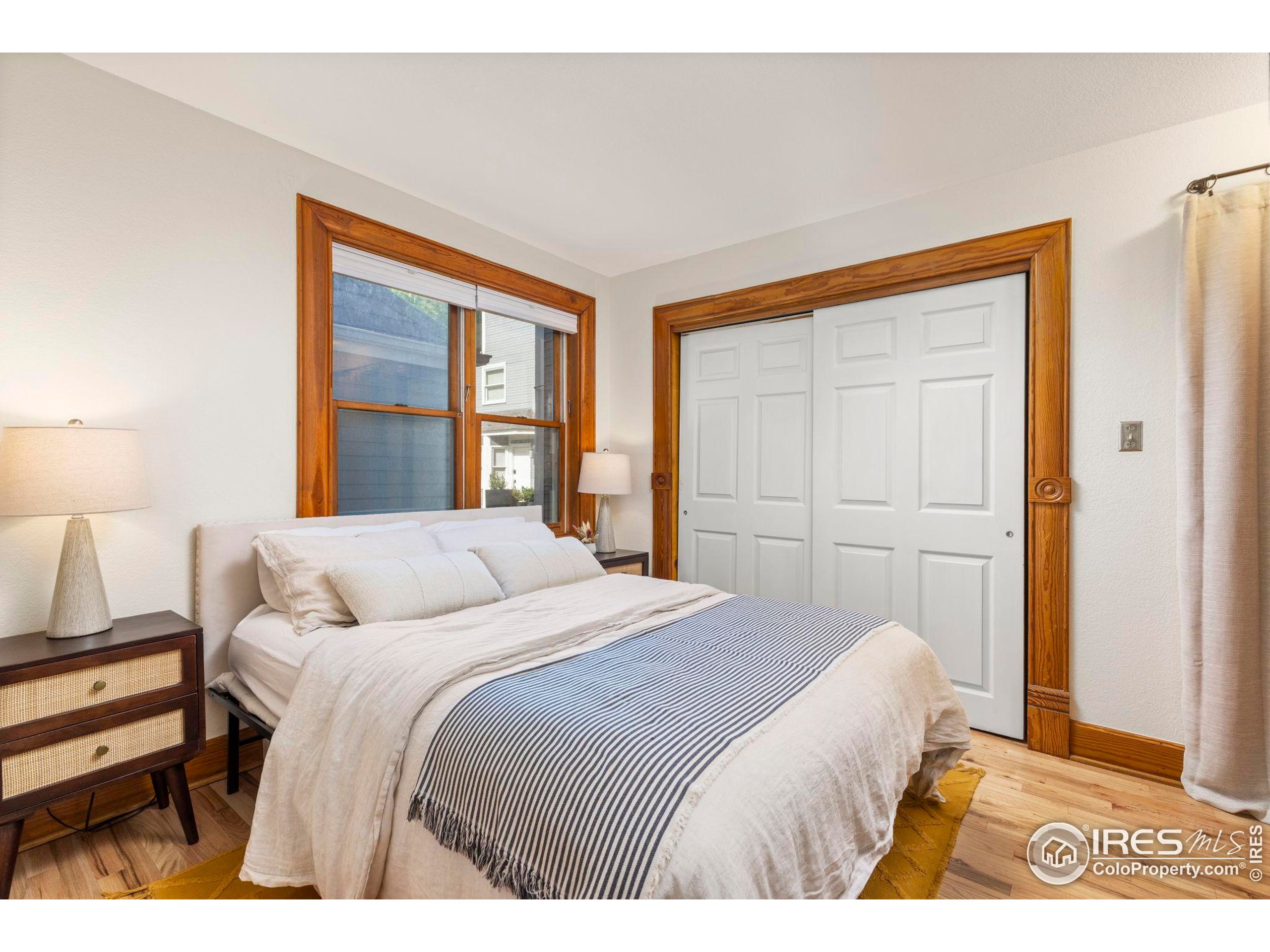 1430 18th Street, Unit 1 Boulder, CO 80302 - Photo 10 of 29 a bedroom with a bed and a window