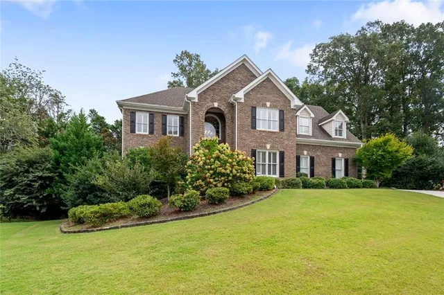 a view of a house with a yard and plants