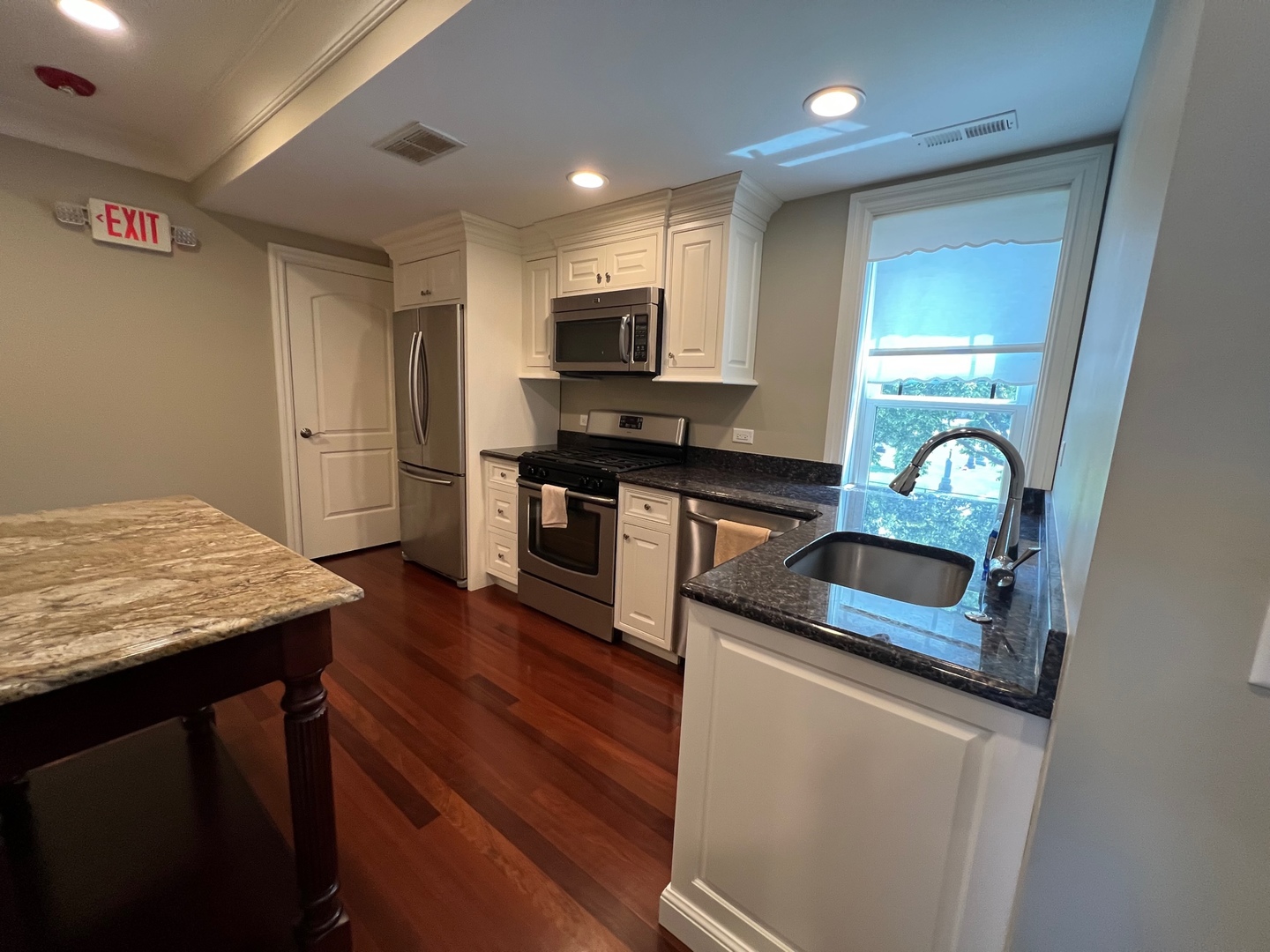 1000 Ridge Road, Unit 2 Wilmette, IL 60091 - Photo 4 of 10 a kitchen with stainless steel appliances granite countertop a sink stove and refrigerator