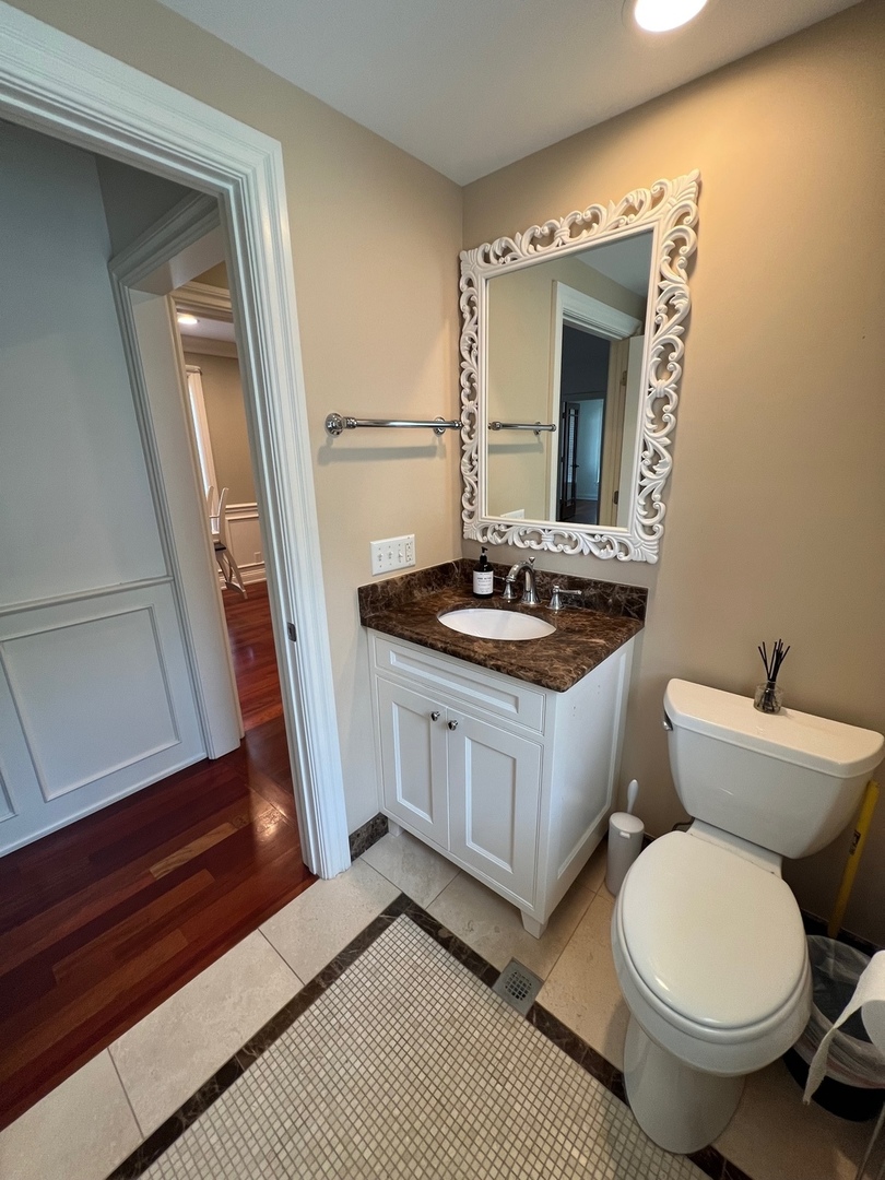 1000 Ridge Road, Unit 2 Wilmette, IL 60091 - Photo 9 of 10 a bathroom with a sink and a mirror