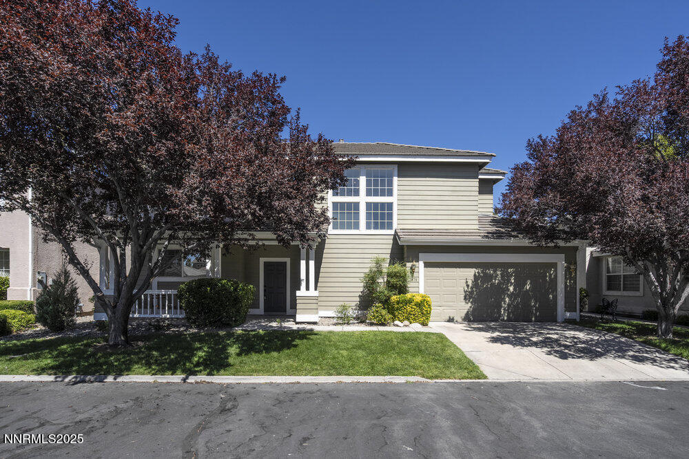 a front view of a house with a yard and garage