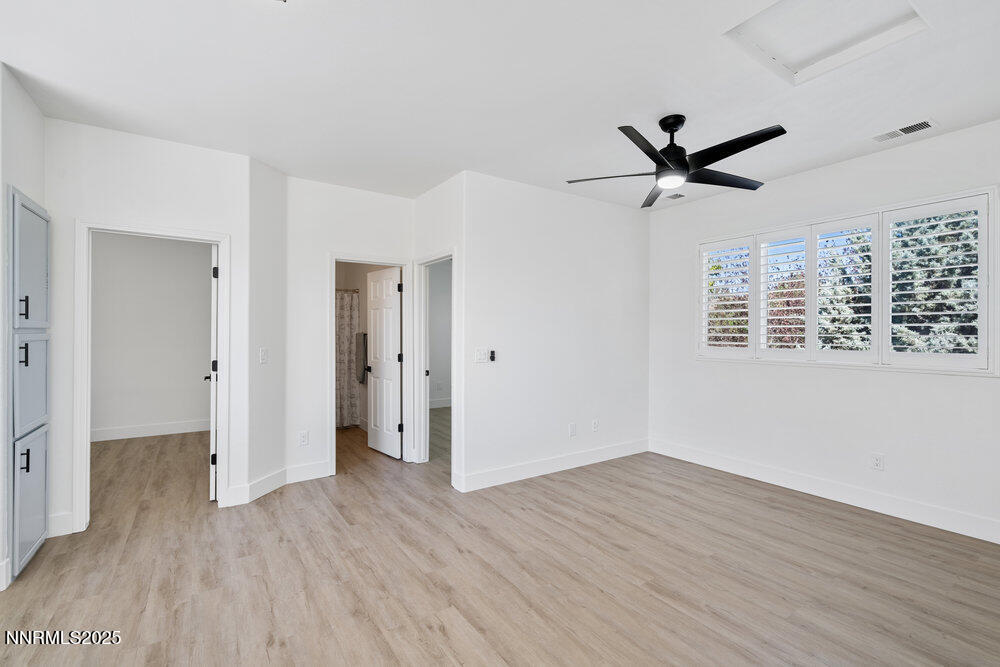 1179 Tule Drive Reno, NV 89521 - Photo 27 of 48 a view of a big room with wooden floor and windows