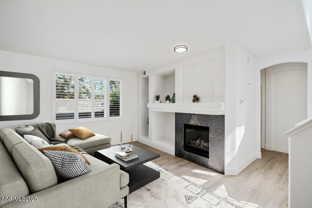1179 Tule Drive Reno, NV 89521 - Photo 6 of 48 a living room with furniture a fireplace and a large window