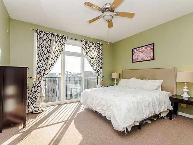 2127 West Rice Street, Unit 4W Chicago, IL 60622 - Photo 16 of 25 a bedroom with a bed and a large window