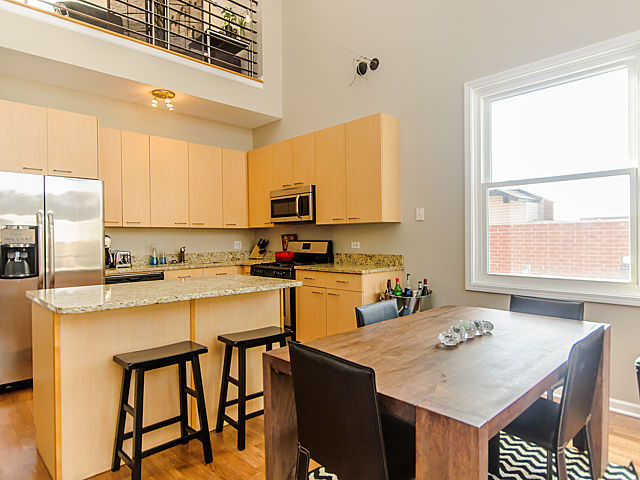 2127 West Rice Street, Unit 4W Chicago, IL 60622 - Photo 5 of 25 a kitchen with a stove a sink and a refrigerator