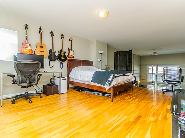 2127 West Rice Street, Unit 4W Chicago, IL 60622 - Photo 9 of 25 a bedroom with furniture and a flat screen tv