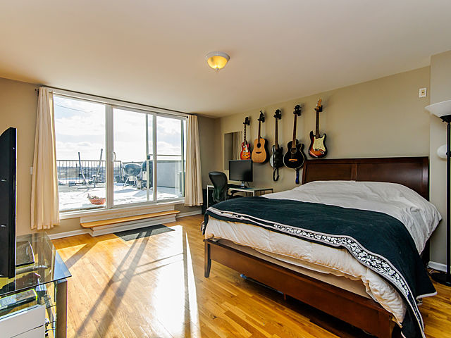 2127 West Rice Street, Unit 4W Chicago, IL 60622 - Photo 10 of 25 a bed sitting in a bedroom next to a window