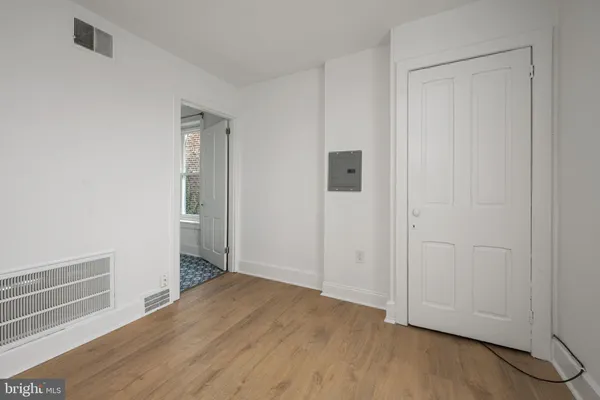a view of empty room with wooden floor