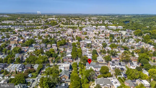 an aerial view of residential houses with city view