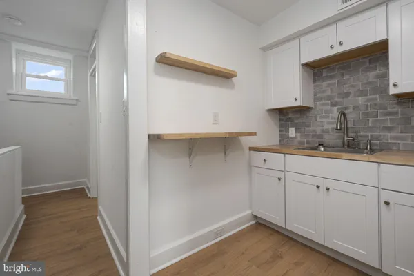 a kitchen with a sink and cabinets