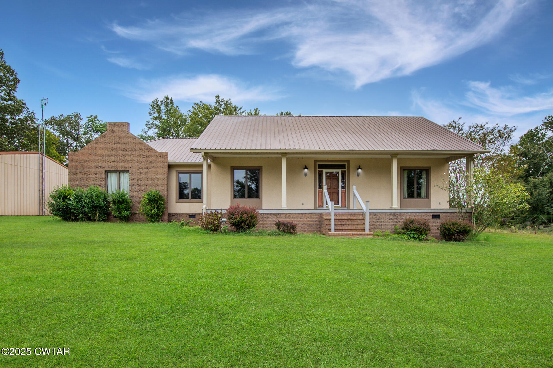 3554 Shades Bridge Road Greenfield, TN 38230 - Photo 2 of 49 a front view of a house with a garden
