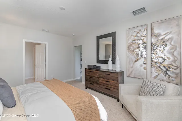 a bedroom with a bed and a couch