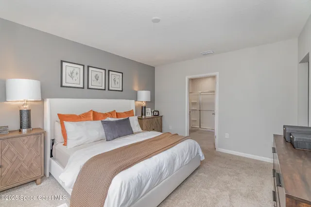 a bedroom with a bed and a night stand