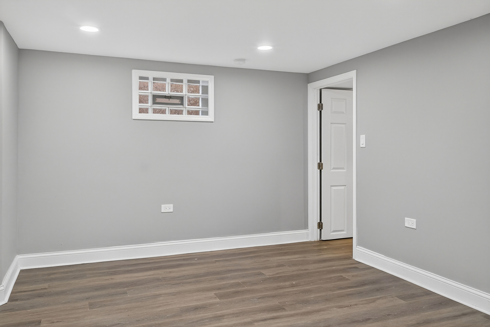 9100 South Wallace Street Chicago, IL 60620 - Photo 24 of 38 a view of an empty room with wooden floor and a window