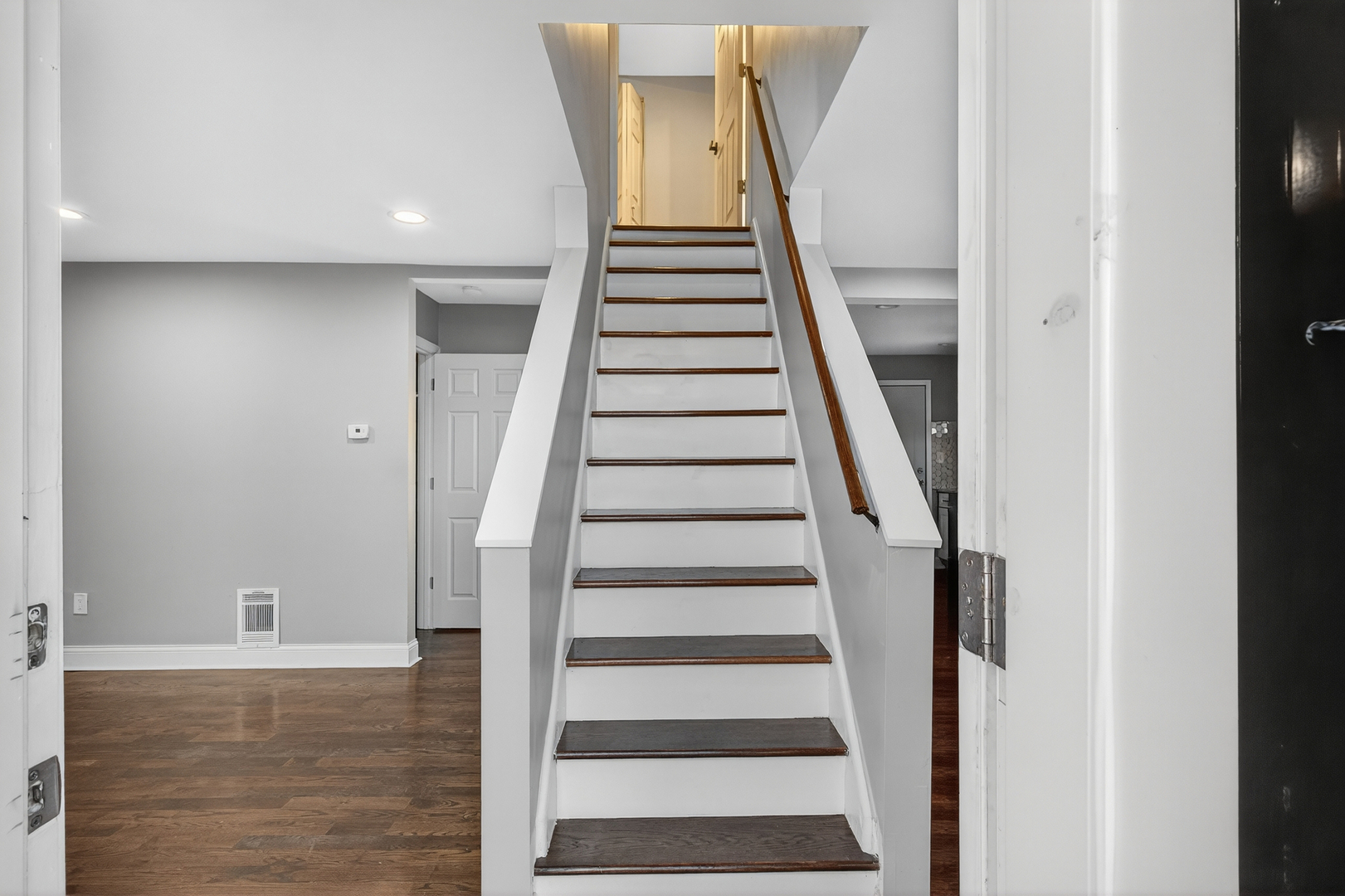 9100 South Wallace Street Chicago, IL 60620 - Photo 6 of 38 a view of staircase with wooden floor and white walls