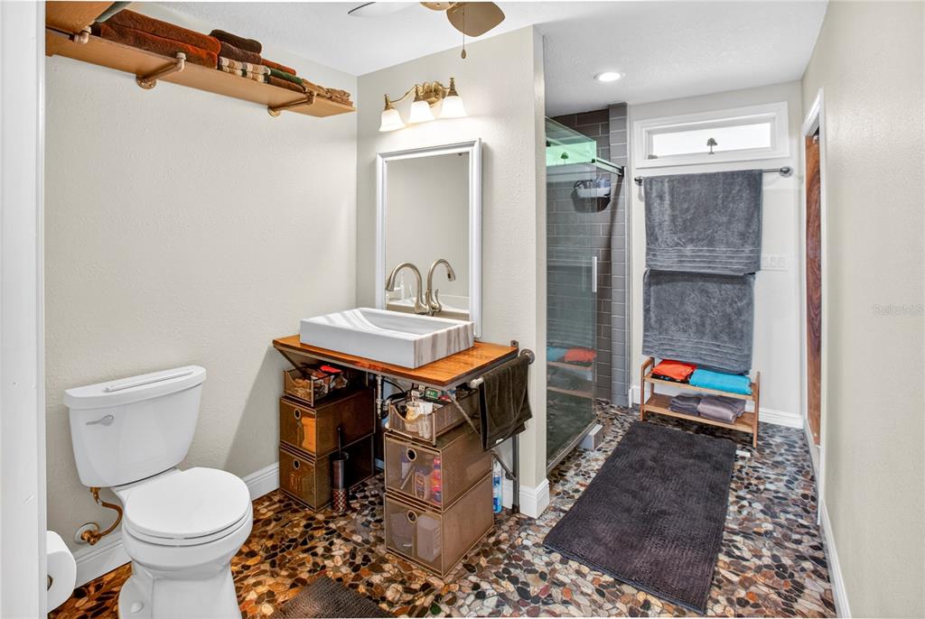 10627 McIntosh Road Thonotosassa, FL 33592 - Photo 11 of 38 a bathroom with a toilet a sink and shower