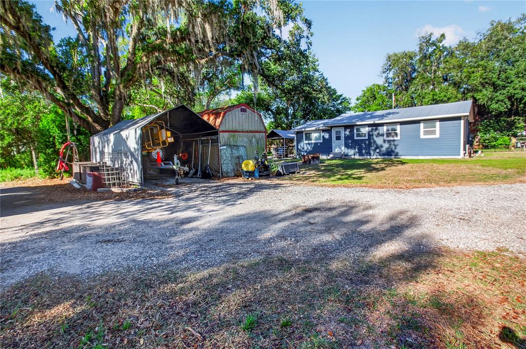 10627 McIntosh Road Thonotosassa, FL 33592 - Photo 16 of 38 a view of a house with backyard and sitting area