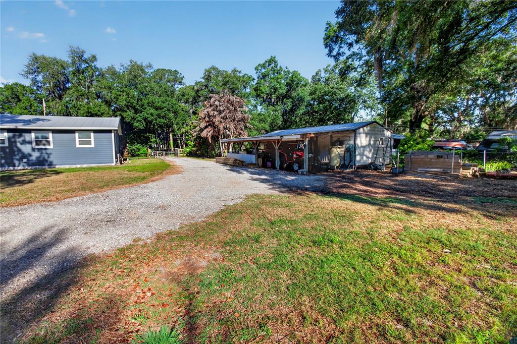 10627 McIntosh Road Thonotosassa, FL 33592 - Photo 18 of 38 a view of a house with swimming pool and sitting area