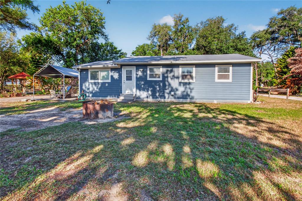10627 McIntosh Road Thonotosassa, FL 33592 - Photo 24 of 38 a view of a house with a yard