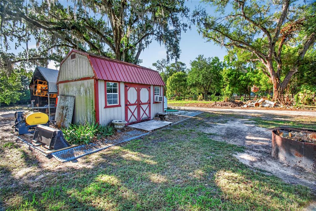 10627 McIntosh Road Thonotosassa, FL 33592 - Photo 28 of 38 a backyard of a house with garden and outdoor seating