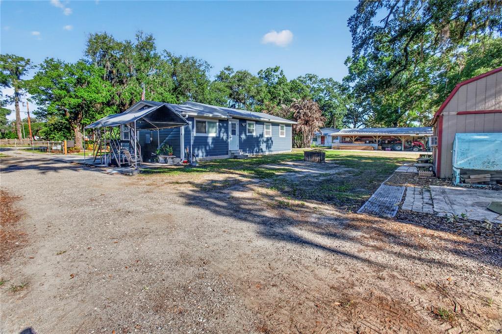 10627 McIntosh Road Thonotosassa, FL 33592 - Photo 30 of 38 a view of a yard in front of a house with large trees