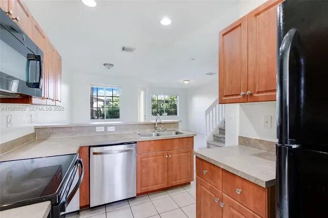 a kitchen with a sink window and cabinets