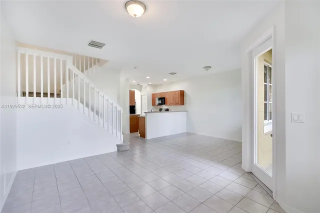 a view of a kitchen with furniture and an empty room