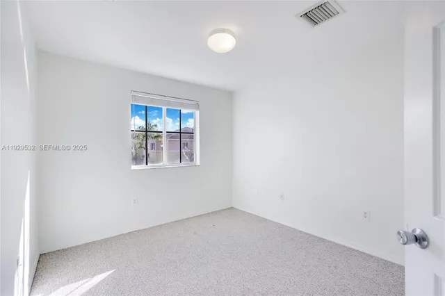 an empty room with windows and window
