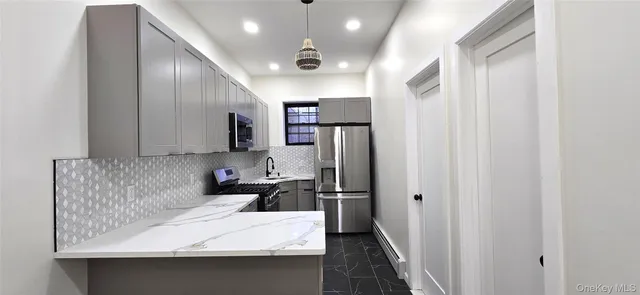 a kitchen with stainless steel appliances sink refrigerator and microwave