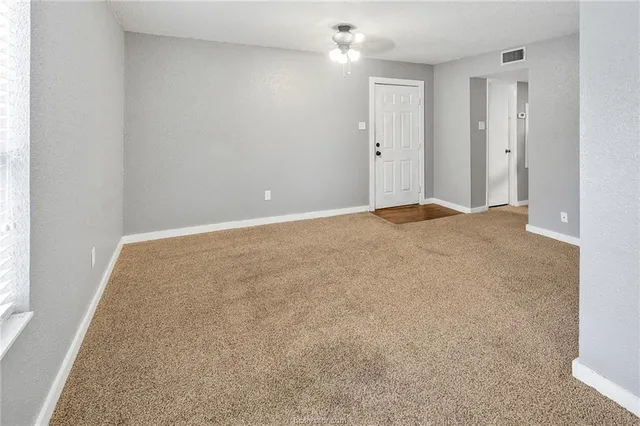 an empty room with windows and closet