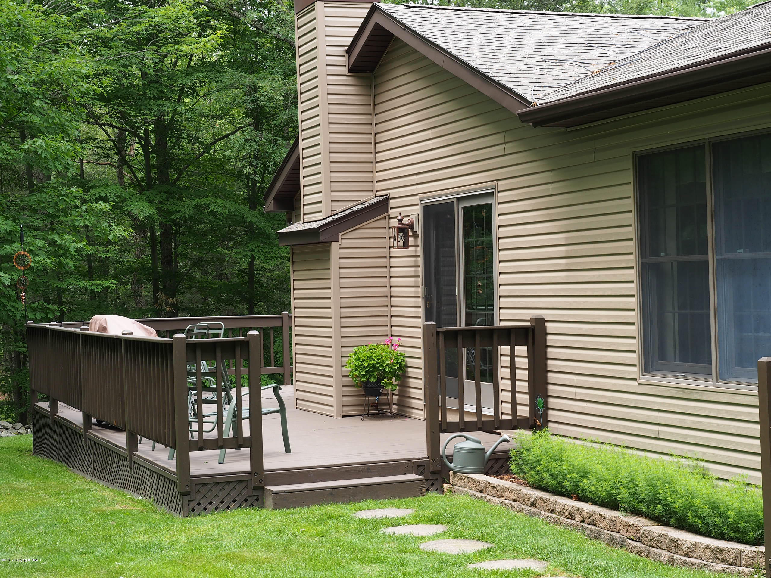 3 Fern Path Road Stroudsburg, PA 18360 - Photo 29 of 35 a view of backyard with a table and chairs and potted plants