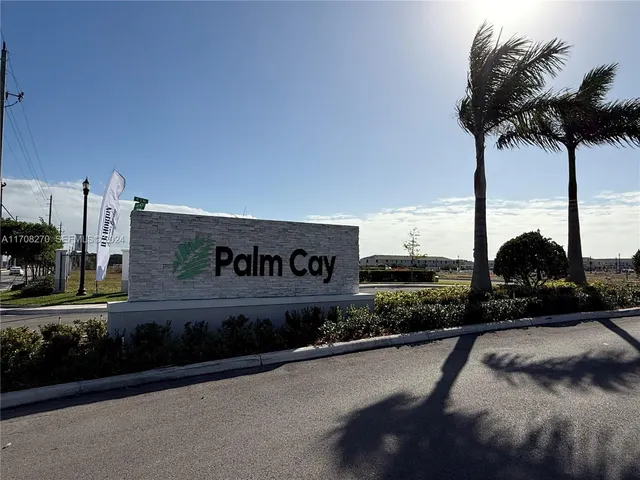 a view of a street with a building and trees in the background