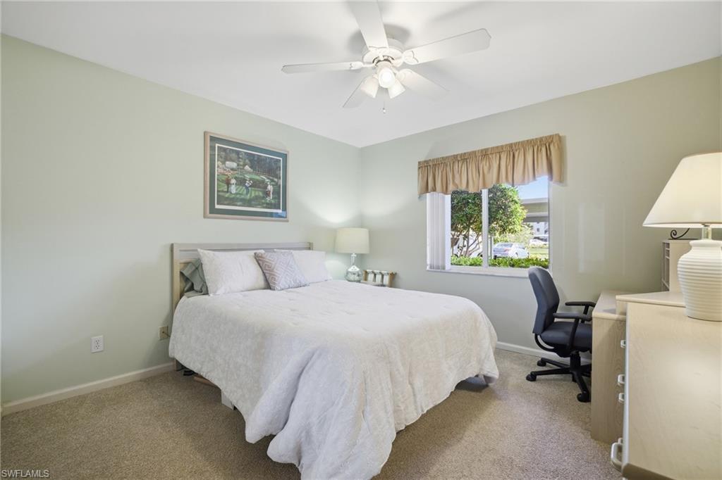 1001 Eastham Way, Unit C102 Naples, FL 34104 - Photo 14 of 41 a bedroom with a bed and a table