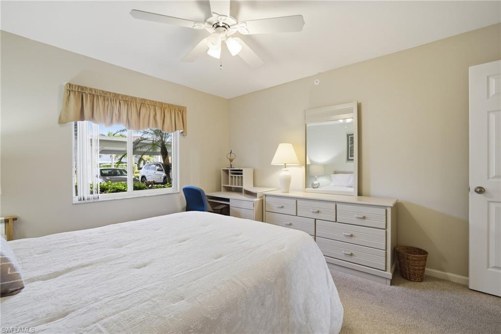 1001 Eastham Way, Unit C102 Naples, FL 34104 - Photo 15 of 41 a bedroom with a large bed and a window