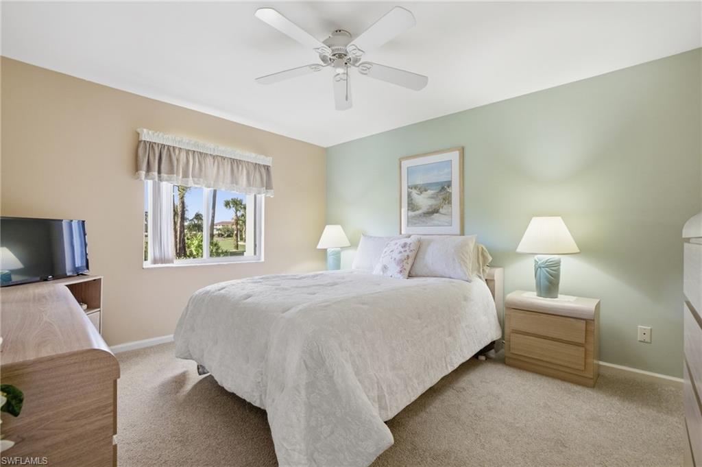 1001 Eastham Way, Unit C102 Naples, FL 34104 - Photo 20 of 41 a bedroom with bed a couch and a window