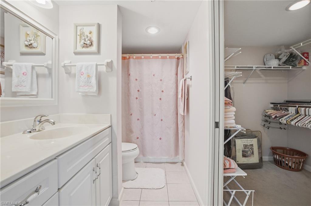 1001 Eastham Way, Unit C102 Naples, FL 34104 - Photo 23 of 41 a bathroom with a sink toilet and shower