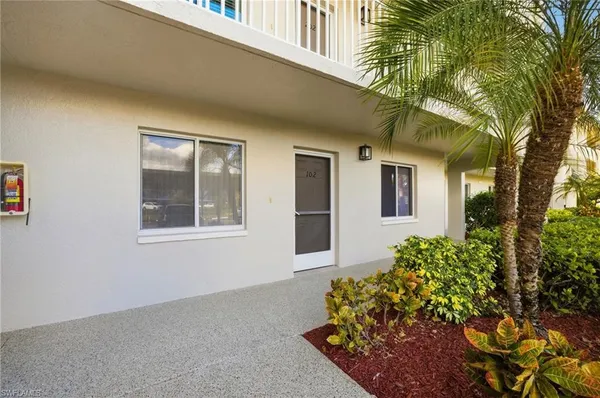 an aerial view of a house with a yard and outdoor seating