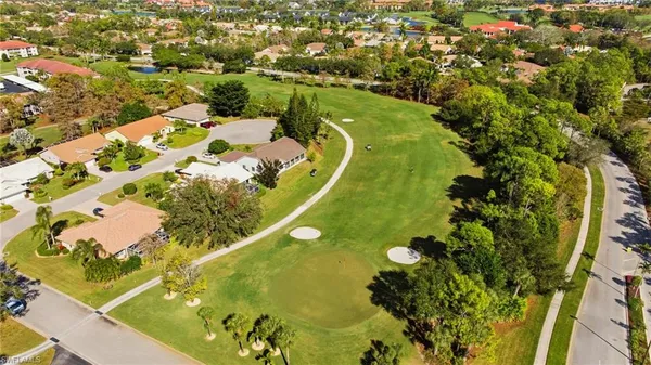 an aerial view of a residential houses with swimming pool