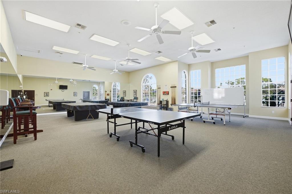 1001 Eastham Way, Unit C102 Naples, FL 34104 - Photo 33 of 41 a room with lots of furniture and a large window