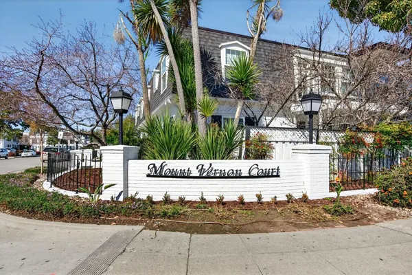 a front view of a building with tree s