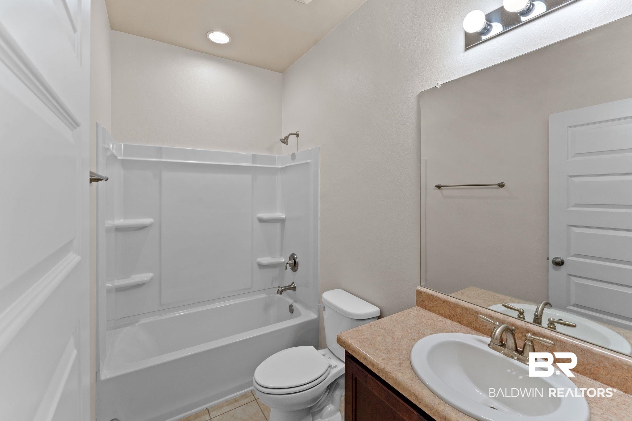 1464 Surrey Loop Foley, AL 36535 - Photo 19 of 24 Bathroom featuring vanity, tub / shower combination, and tile patterned floors