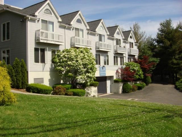 115 Flax Hill Road, Unit 4 Norwalk, CT 06854 - Photo 1 of 1 a front view of a house with a yard and trees