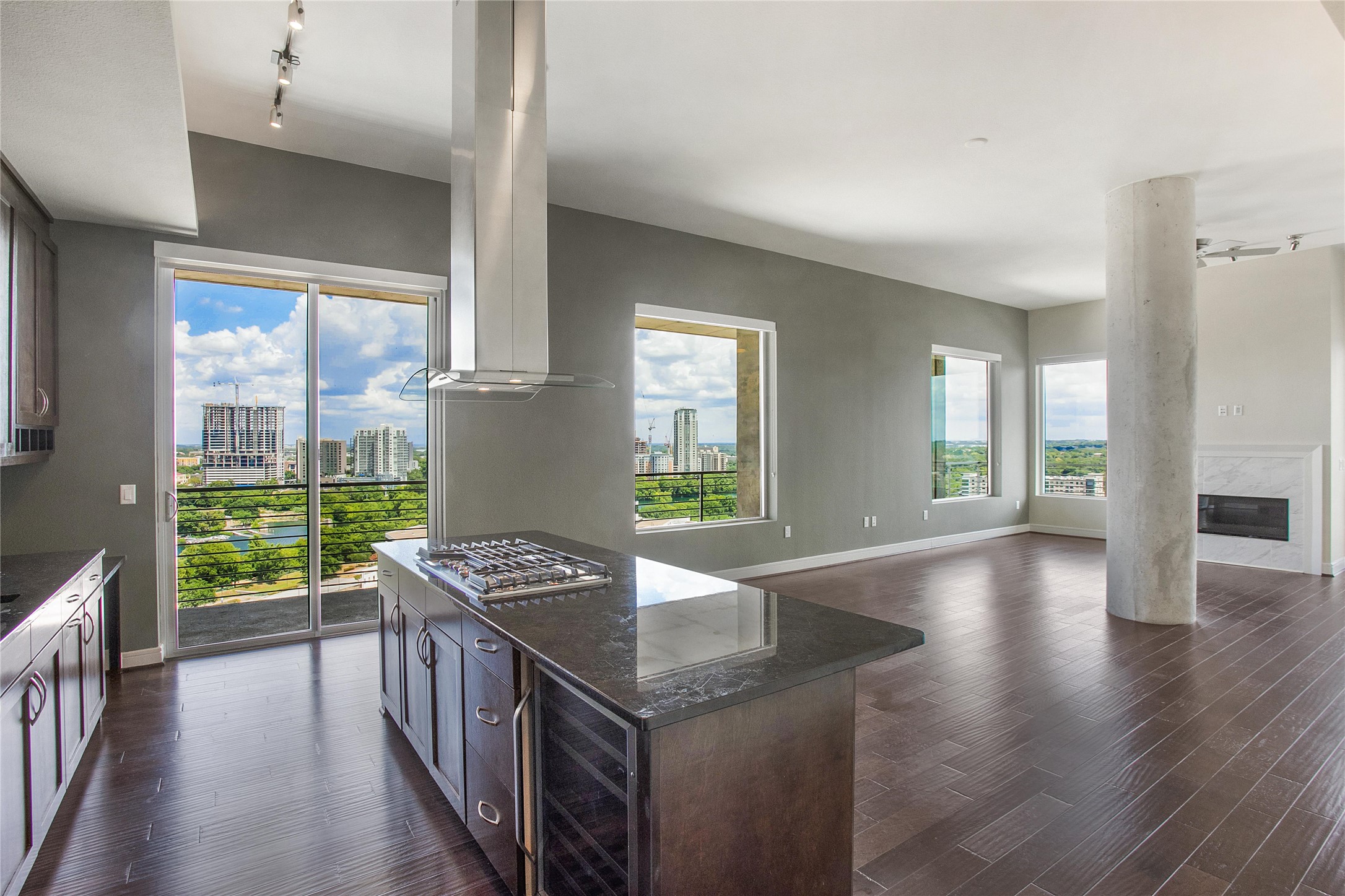 214 Barton Springs Road, Unit 1910 Austin, TX 78704 - Photo 4 of 22 Rich hardwood floors anchor this open kitchen and living area overlooking a dynamic cityscape view.