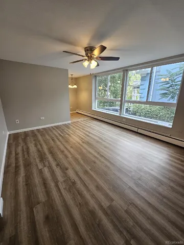 wooden floor in an empty room with a window