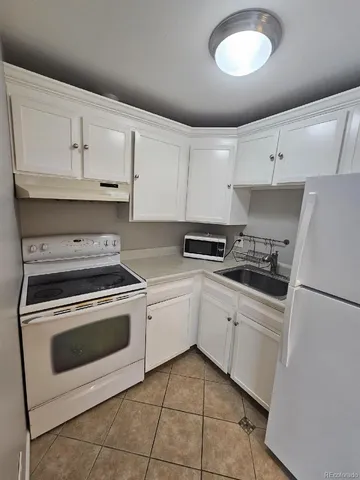 a kitchen with cabinets stainless steel appliances and a sink