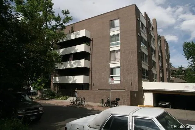 a couple of cars parked in front of building